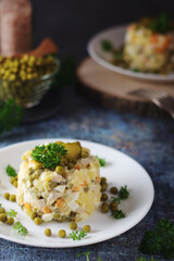Olivier salad, traditional Russian dish, served on the plate	