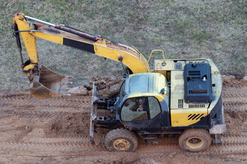 A wheel loader digs the ground at a construction site to pave a road