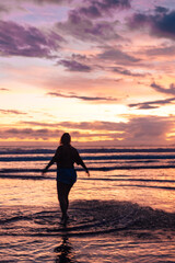 silhouette of a person on the beach at sunset