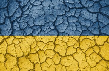 Ukrainian national flag pattern cracked earth, war concept