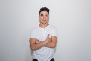 nice guy, dark-haired, white test, white t-shirt, looking straight ahead, neutral background