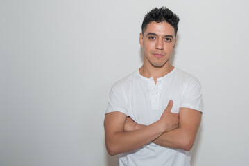 nice guy, dark-haired, white test, white t-shirt, looking straight ahead, neutral background