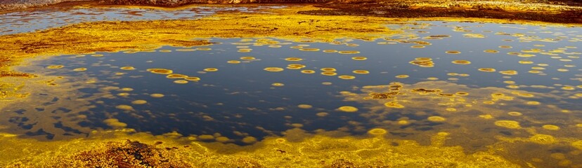 Panorama of surreal colors and Mars like landscape created by Sulphur springs in the hottest place on earth, the Danakil Depression in the Afar Region of Ethiopia.
