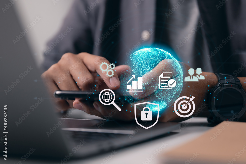 Aufkleber Businessman interacts with his smartphone while holding it up to the digital internet world. Digital networking and business on the Internet technology.