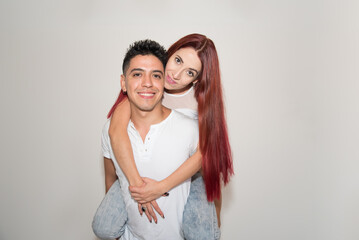 embracing couple, smiling, with neutral background, dark-haired boy, red-haired girl