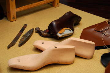 shoemaker tools and lasts in workshop. Craft tools for leather