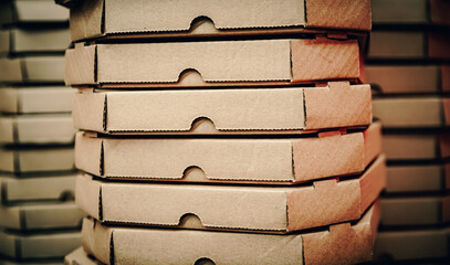 Close-up of stacks with pizza cardboard boxes