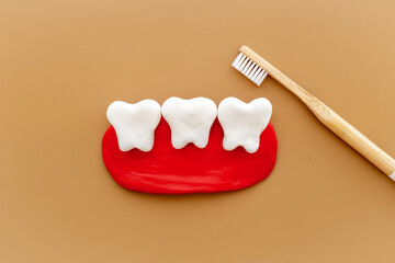 Fototapeta na wymiar Teeth models with caries or plaque and toothbrush. Oral health concept