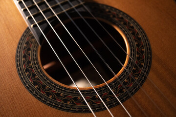 Classical guitar on black background. Acoustic guitar concept.Perfect for flyer, card, poster or wallpaper