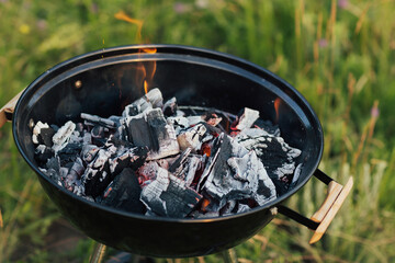 Burning coal in barbeque. Summer season barbeque.