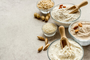 Fototapeta na wymiar Gluten free flour in bowls. Almond peanut oat and rice buckwheat flour in bowls