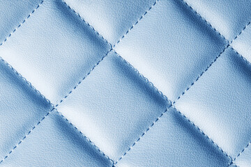 Fototapeta premium Blue leather texture. Macro fashion background. Women hand bag closeup backdrop. Grunge artificial pattern. Furniture thread sew.
