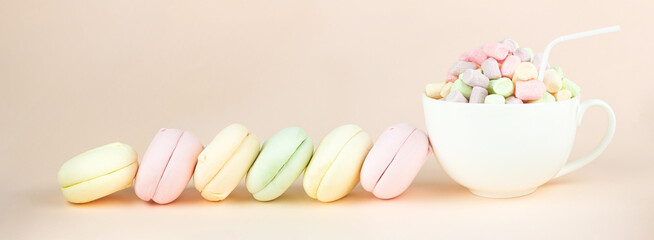 Delicious Sweet Colorful marshmallows looks like Macarons with porcelain white coffee cup mug, colorful almond cookies, pastel colors