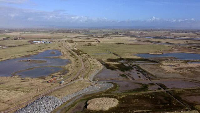 Aerial footage of Medberry nature reserve and the rifes and lakes, a haven for birds on the South Coast of England in Bracklesham Bay.
