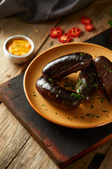 Morcilla, a traditional Ecuadorian sausage. On a wooden background