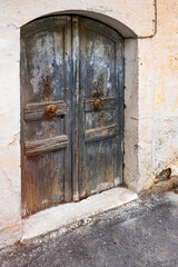 Very old wooden door and broken masonry