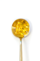 Omega 3 supplement on a spoon isolate on a white background. Selective focus.