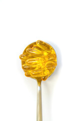Omega 3 supplement on a spoon isolate on a white background. Selective focus.