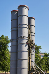 the launcher of an anti-aircraft missile and gun complex is hidden in green foliage