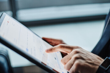 businessman analyzing a graph of financial growth on his tablet.