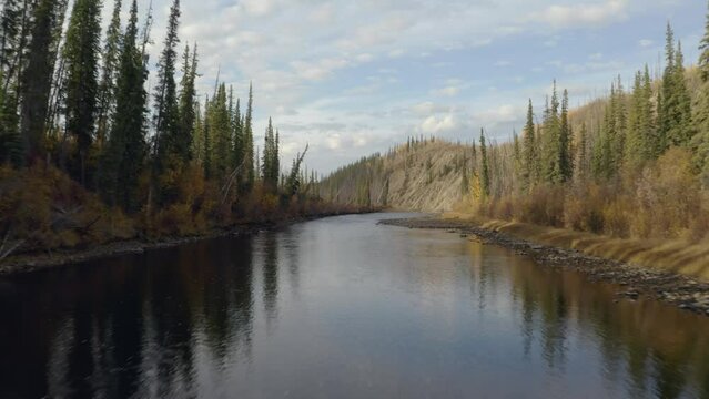 Wild alaska river for fishing, camping, hunting. during sunset in alaska with a wide alaskan river bank from above the air with drone alaska. ESTABLISHING SHOT