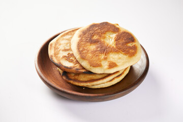 Tortilla de maiz a traditional Ecuadorian appetizer and served with coffee. It’s on a white background. 