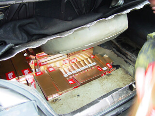 A car boot stuffed full of cigarette cartons and boxes - This is the real thing from KFOR, Kosovo...