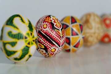 Five painted eggs stand in a line. Traditional Easter ornament.