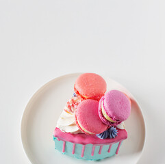 piece of cake with pink and blue decor on white plate