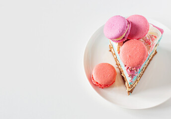 piece of cake with pink and blue decor on white plate