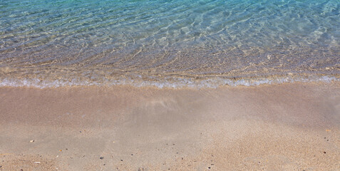 Fototapeta na wymiar Sandy beach, ocean sea water touch wet sand close up. Greece summer vacation