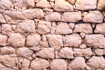 Stone wall painted background, texture. Old stonewall traditional pattern building facade, material