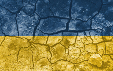 Ukrainian national flag pattern cracked earth, war concept