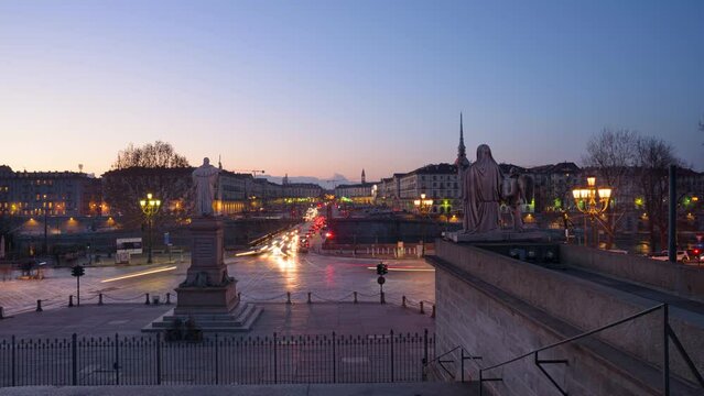 Turin, Italy. February 15, 2022. View from the Gran Madre di Dio Church on the evening car traffic on Corso Casale and the Vittorio Emanuele I Bridge. From Dusk to Night Timelapse.