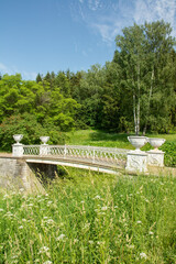 The view of the 19th century cast-iron bridge over the Slavyanka River in summertime in Pavlovsky Park, Saint Petersburg, Russia