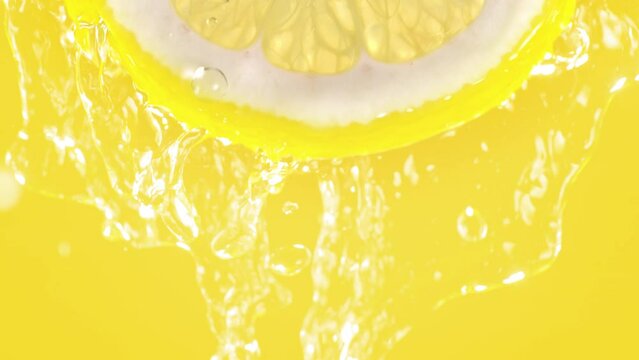 Lemon Slice Splashed by Water from Top in Slow Motion on Yellow Background