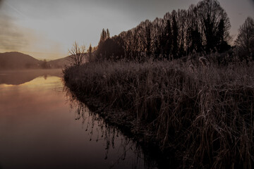 foggy winter morning on the Adda river in Brivio Lombardy - 489251606