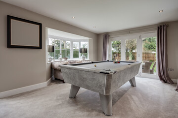 Pool table and sofa in luxury home