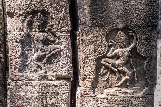 Stone-carved bas-relief with dancing apsaras in ancient Khmer temple in Angkor, Siem Reap, Cambodia