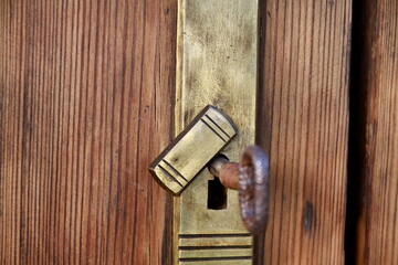 old door with metal handles with key and no people 
stock photo