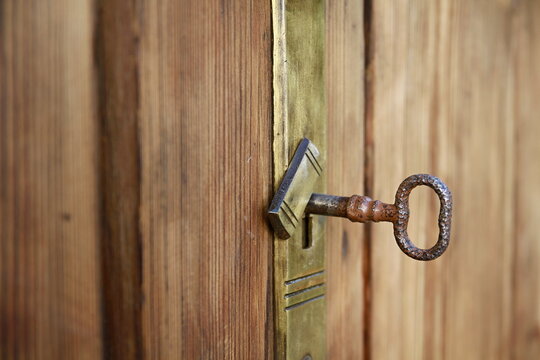 old door with metal handles with key and no people 
stock photo