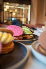 Colourful danish fastelavnsbolle with jam, whipped cream and almond paste in laminated pastry dough with powdered sugar on top served in Copenhagen, Denmark in a cafe bakery Andersen Bakery