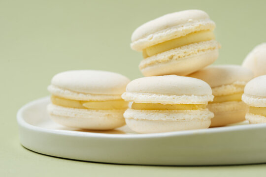 Pile of vanilla macarons on plate