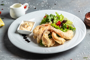 Shrimp fried in batter and sauce with salad. Healthy food, keto diet, diet lunch concept, vertical image. top view. place for text