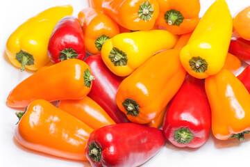 Mixed mini bell peppers on white background. Sweet paprika assortment