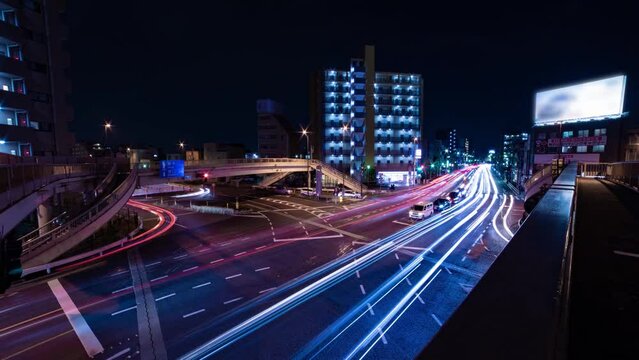 A night timelapse of the traffic jam at the crossing in Tokyo wide shot tilt