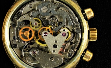 The watch is mechanical, a view of the details from the inside. Round gear gears transmit...