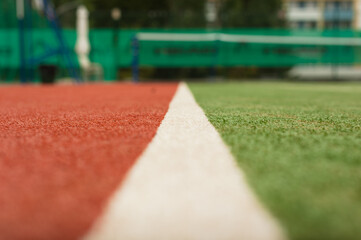 Separation line on the tennis court with artificial turf. Photo with low depth of field and copy space