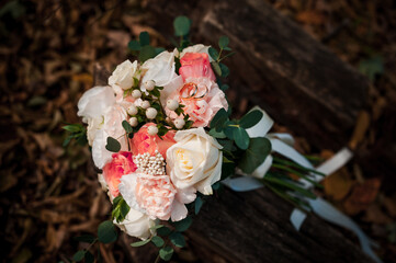 Golden wedding rings, beautiful bridal bouquet of flowers
