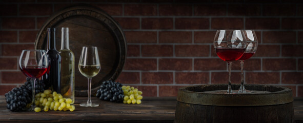 Wine glasses with tall stem. Old oak barrel in a dark wine cellar at the winery. Aging cellaring wine tasting